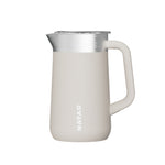 White milk pitcher with silver top on a white background