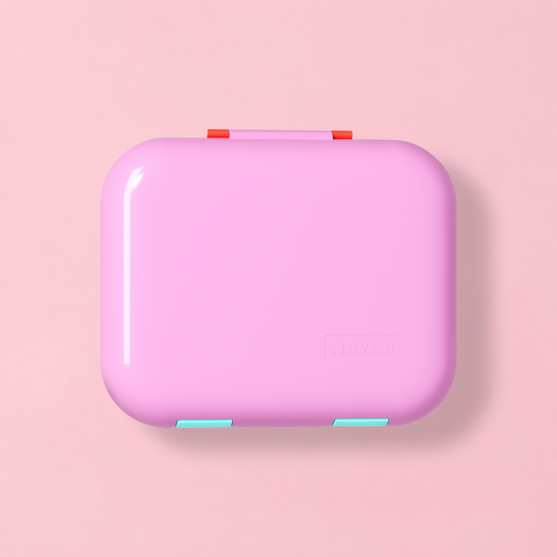 Pink rectangular bento box case with a red handle on a pink background