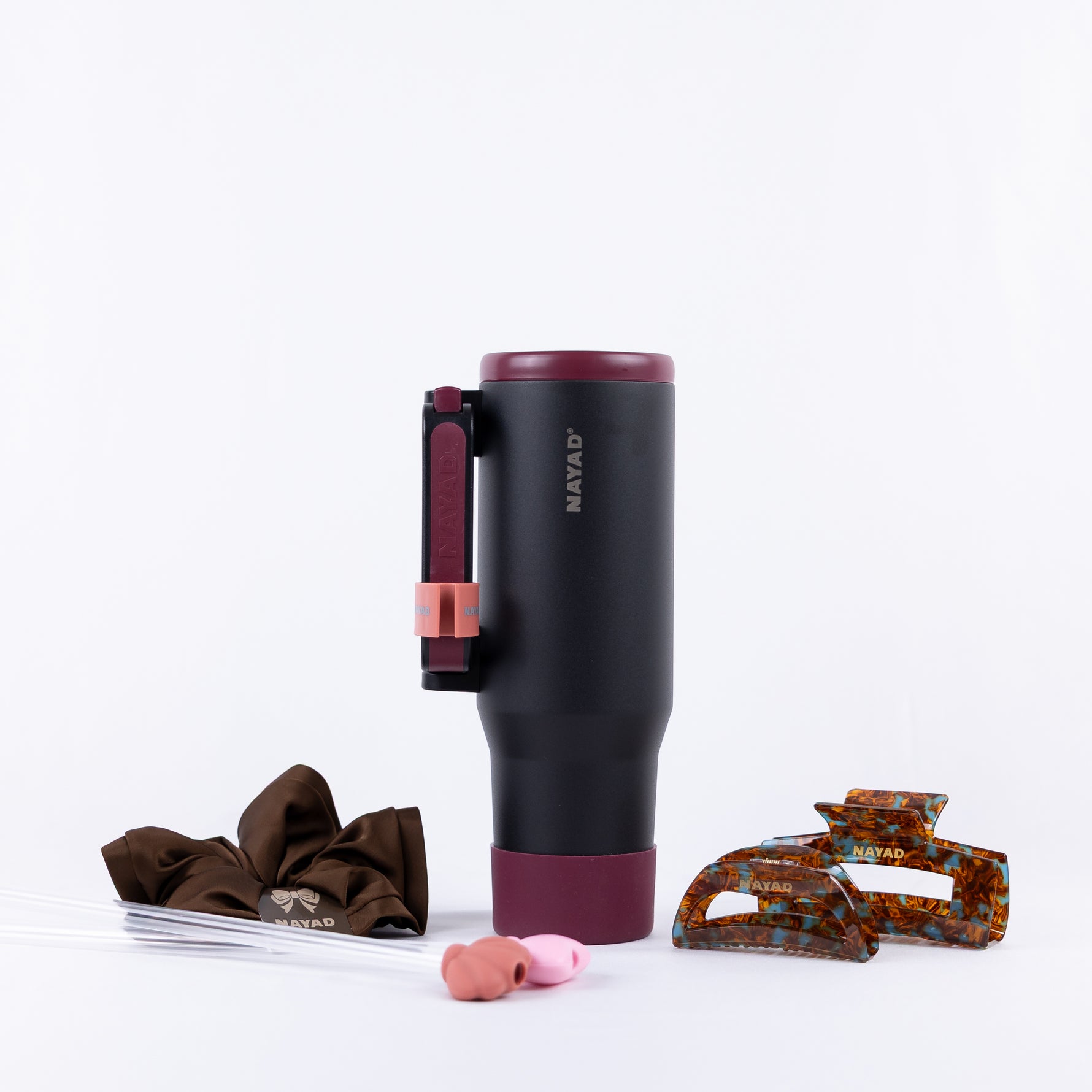 Black Hydrocore Nayad water tumbler with hair clips and comb and straws