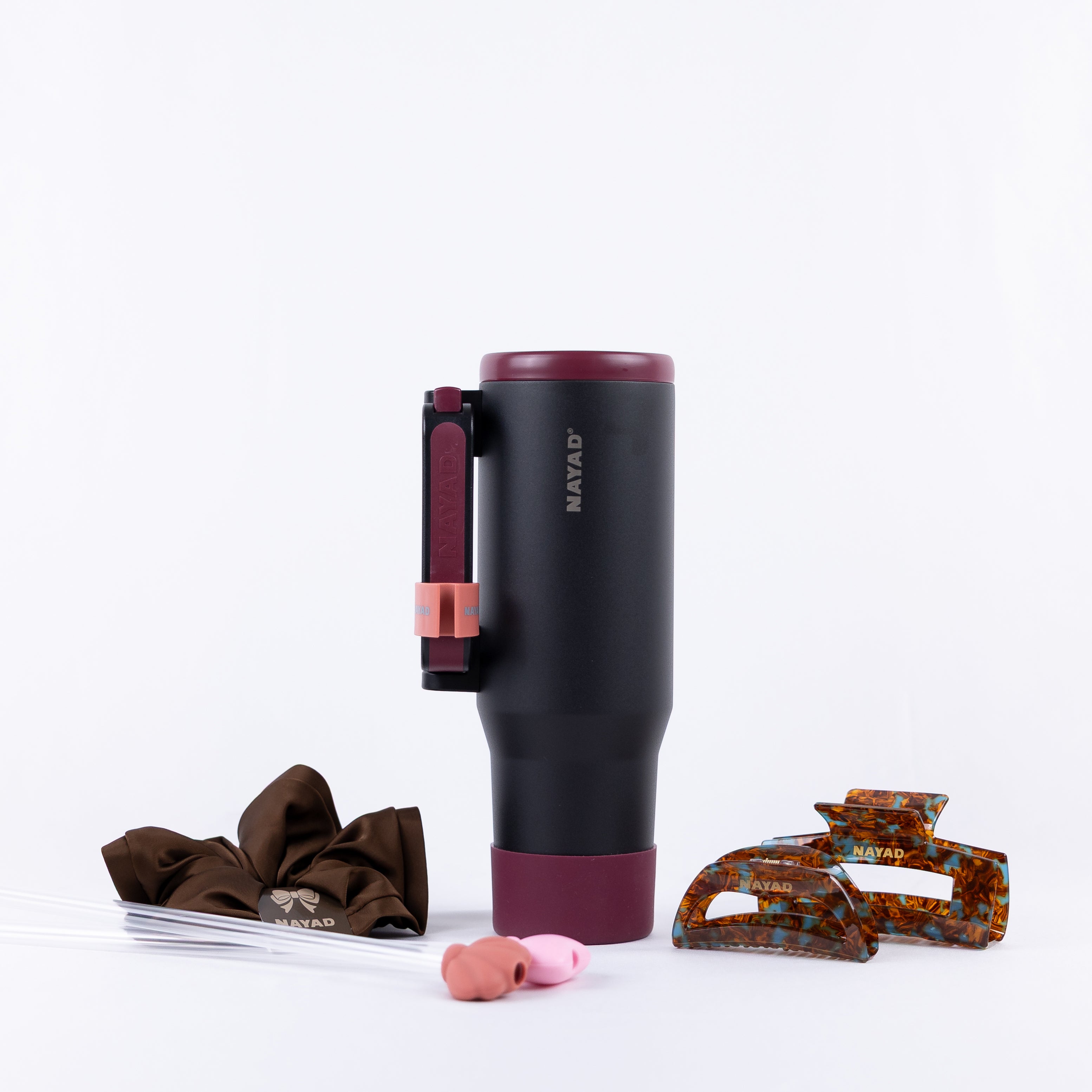 Black Hydrocore Nayad water tumbler with hair clips and comb and straws