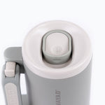 Close-up of a gray and white thermos with 'NAYAD' branding on a white background