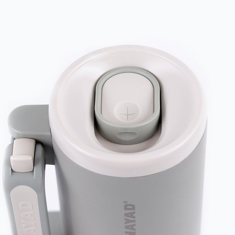 Close-up of a gray and white thermos with &