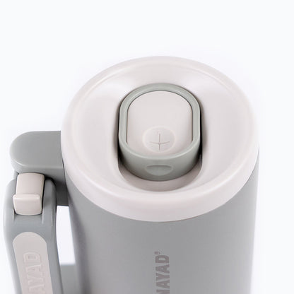 Close-up of a gray and white thermos with &
